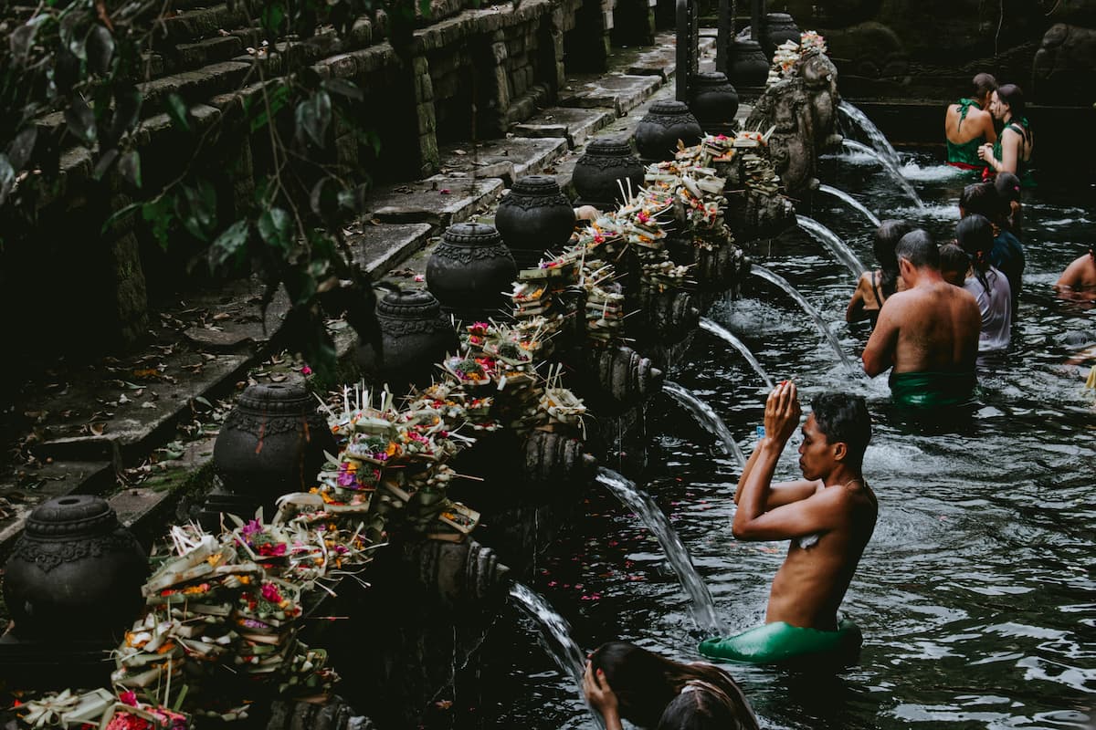 Pilgrims bathing in the holy spring water at Tirta Empul Temple, Bali