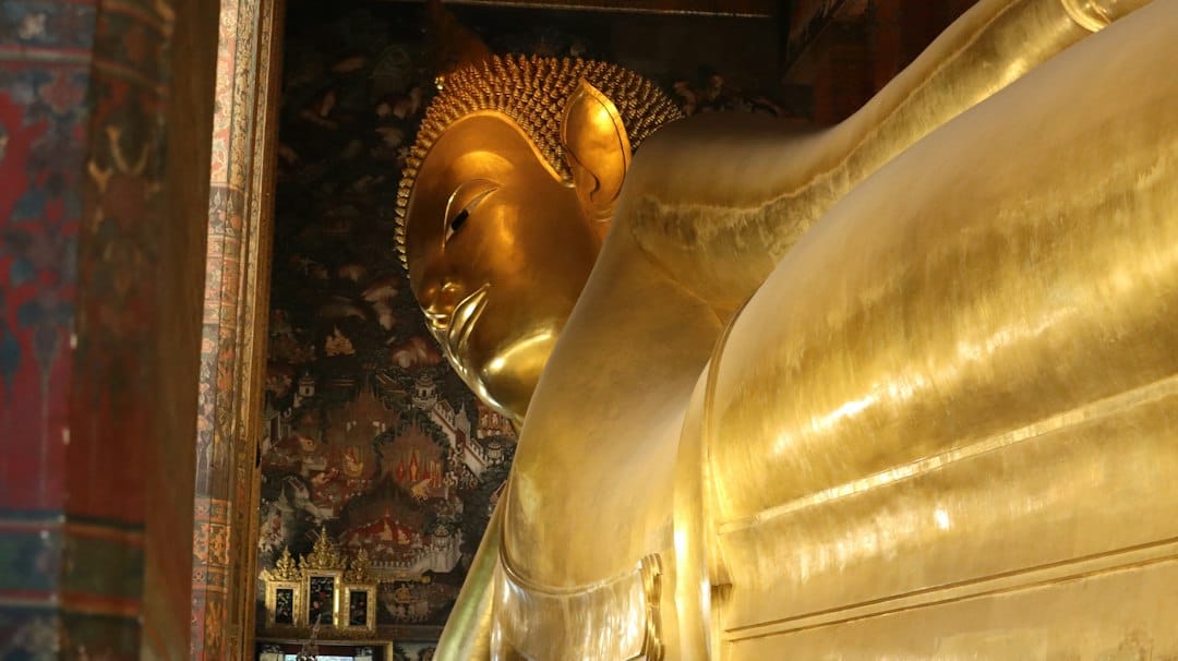 The golden reclining Buddha statue at Wat Pho temple in Bangkok, Thailand. Photo by Nino Steffen on Unsplash