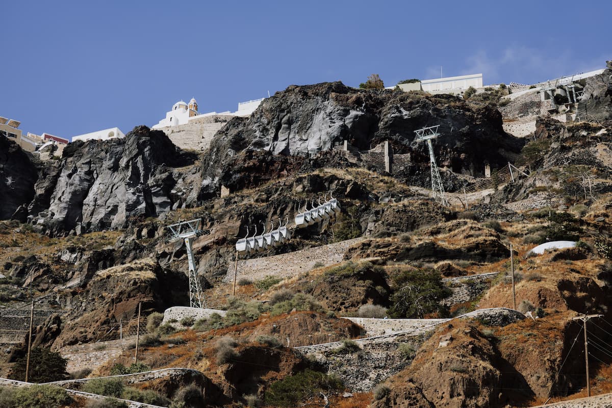 Santorini's cable car cabins descending the cliff toward the old port