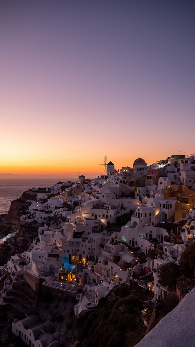 Sunset over Oia's whitewashed village and windmills, Santorini