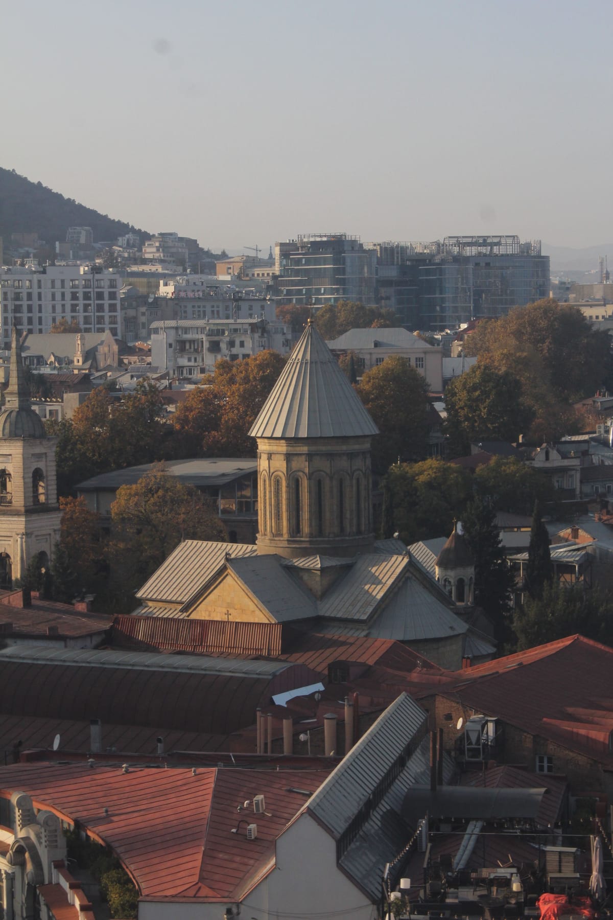 Aerial view of Sioni Cathedral's bell tower rising above Tbilisi's Old Town rooftops