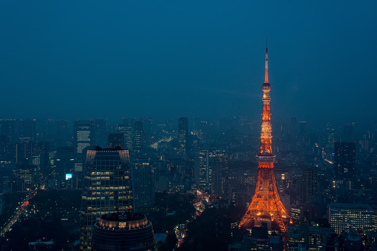 Tokyo Tower illuminated over the city skyline at dusk